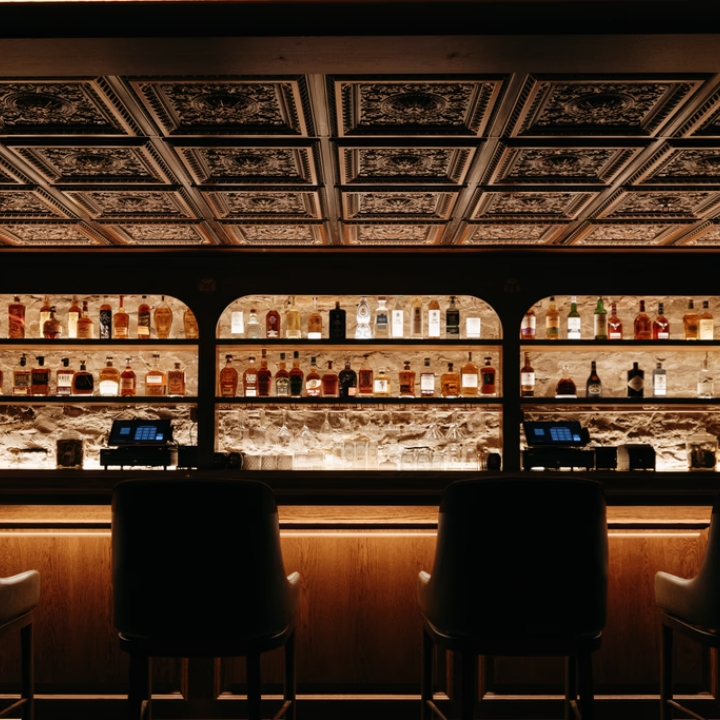 dimly lit photo of a speakeasy-style cocktail bar