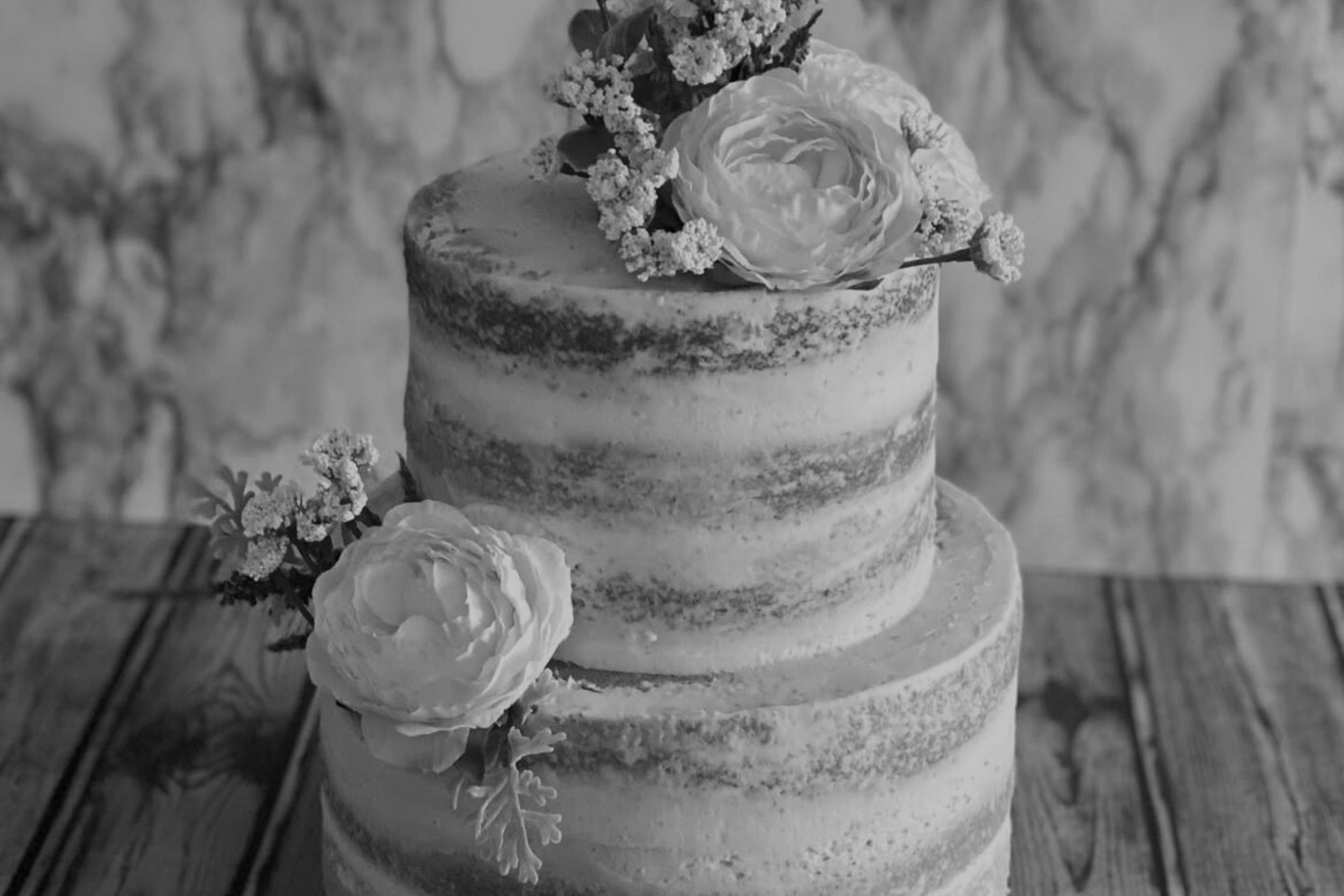 lightly frosted cake with flower decor