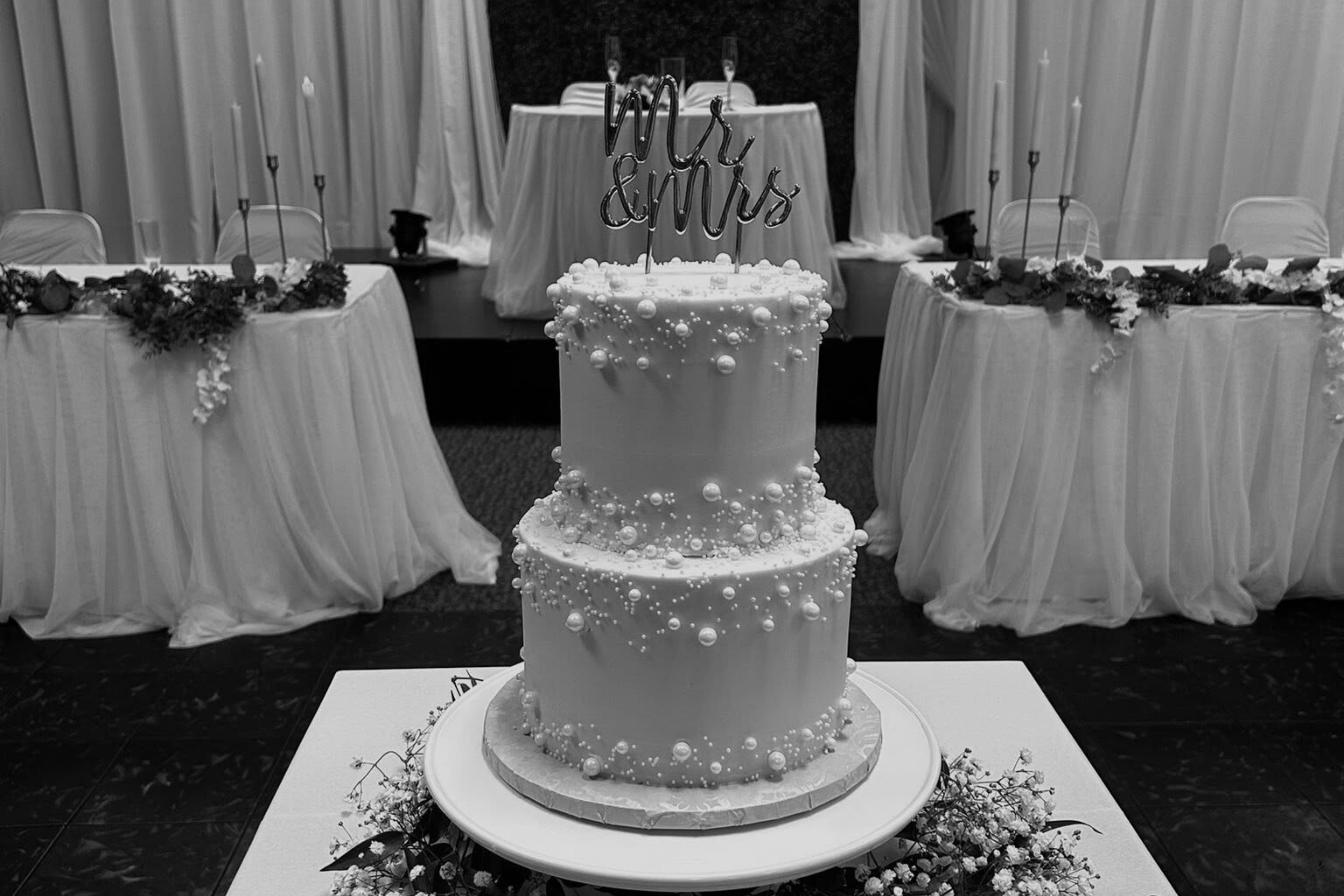 wedding cake adorned with pearl decorations