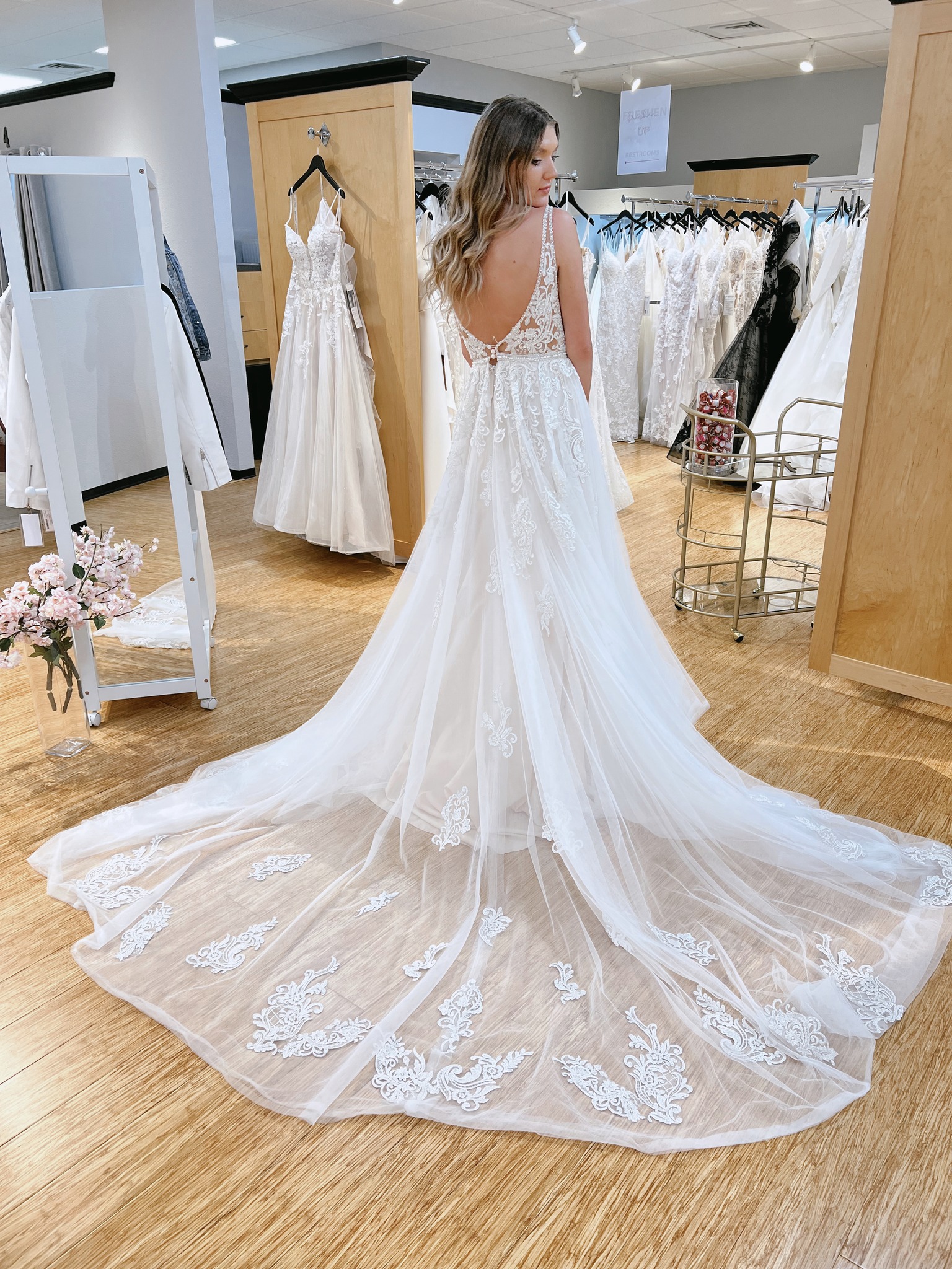 bride looking over her shoulder at the back of a dress