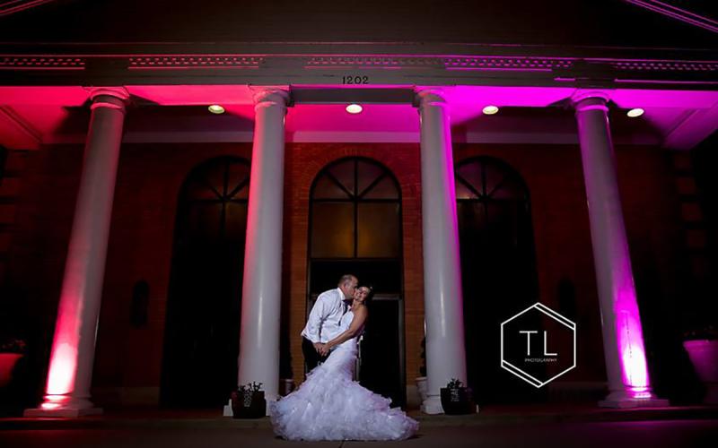 bride and groom kissing outside of the main entrance of the Thelma Keller Convention Center