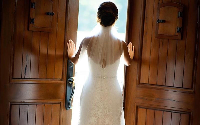 bride looking out the doors of Tuscan Hills Winery