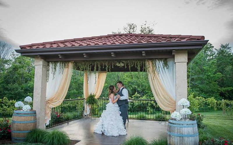 bride and groom dancing under the pergola at Tuscan Hills Winery